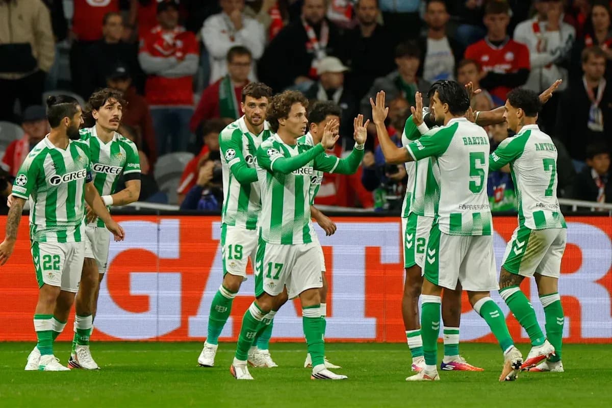 Real Betis players celebrating a goal on the pitch Real Betis players celebrating a goal on the pitch