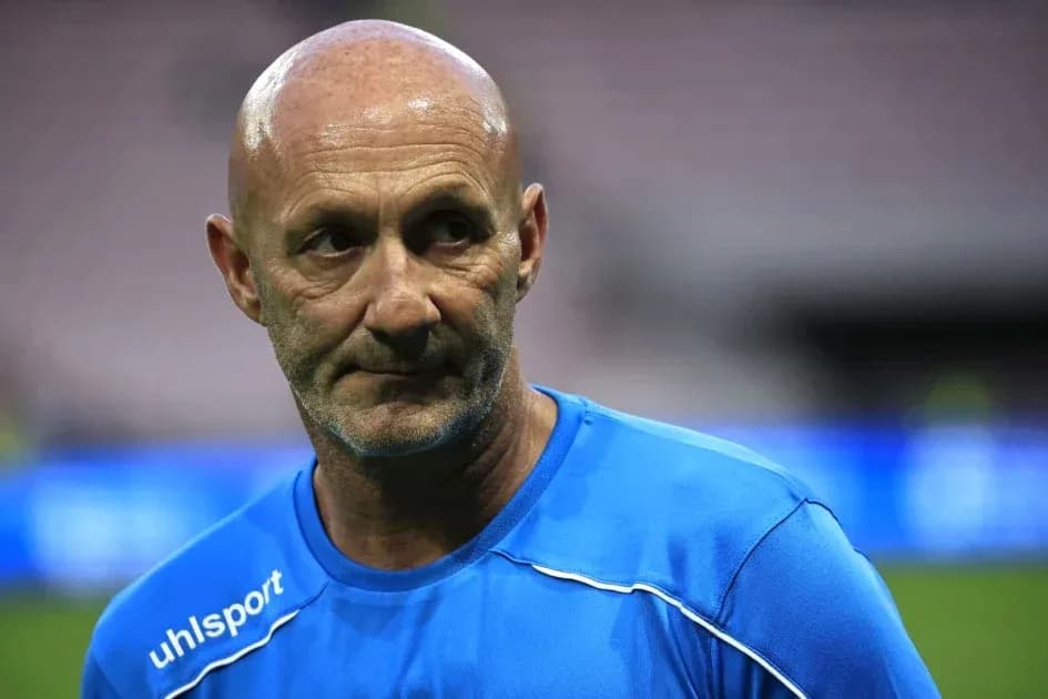 Coach in blue training kit during match preparation Coach in blue training kit during match preparation