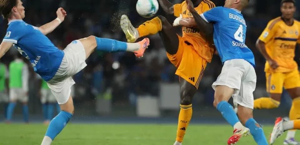 Pisa player kicking ball against Napoli players Pisa player kicking ball against Napoli players
