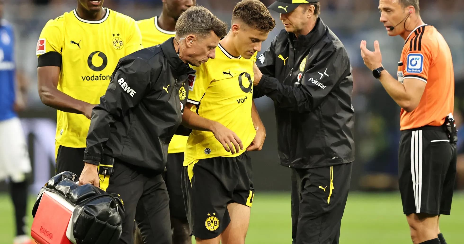 Borussia Dortmund player receiving medical attention on field Borussia Dortmund player receiving medical attention on field