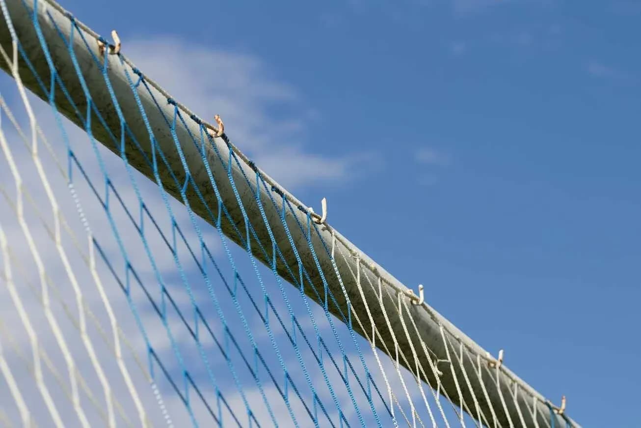 Close-up of a goal net against blue sky Close-up of a goal net against blue sky