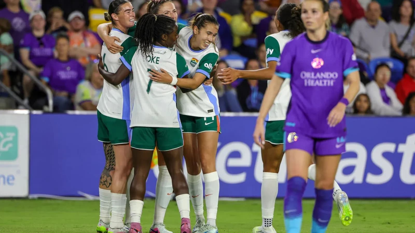 Players celebrating a goal in NWSL match Players celebrating a goal in NWSL match