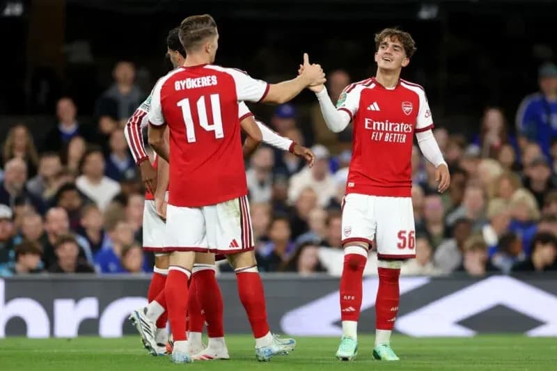 Arsenal players celebrating on the pitch Arsenal players celebrating on the pitch