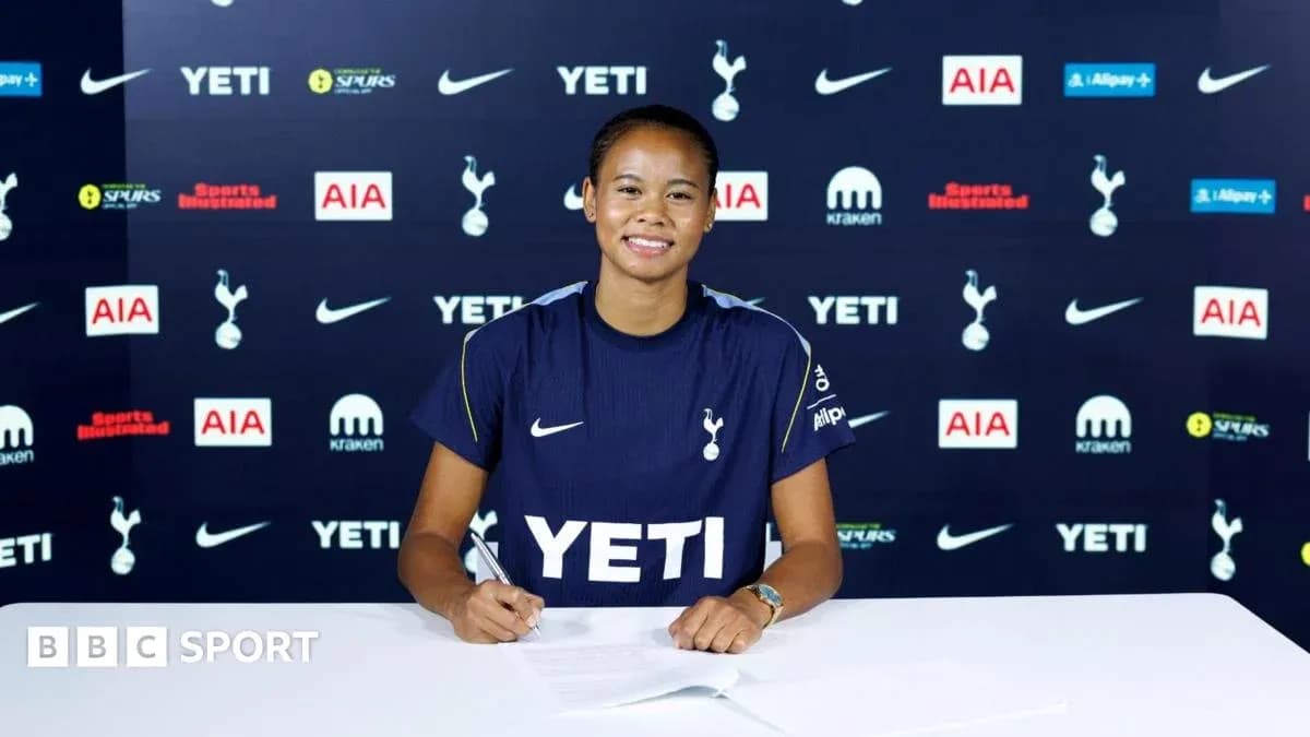 Player signing contract at Tottenham press conference Player signing contract at Tottenham press conference