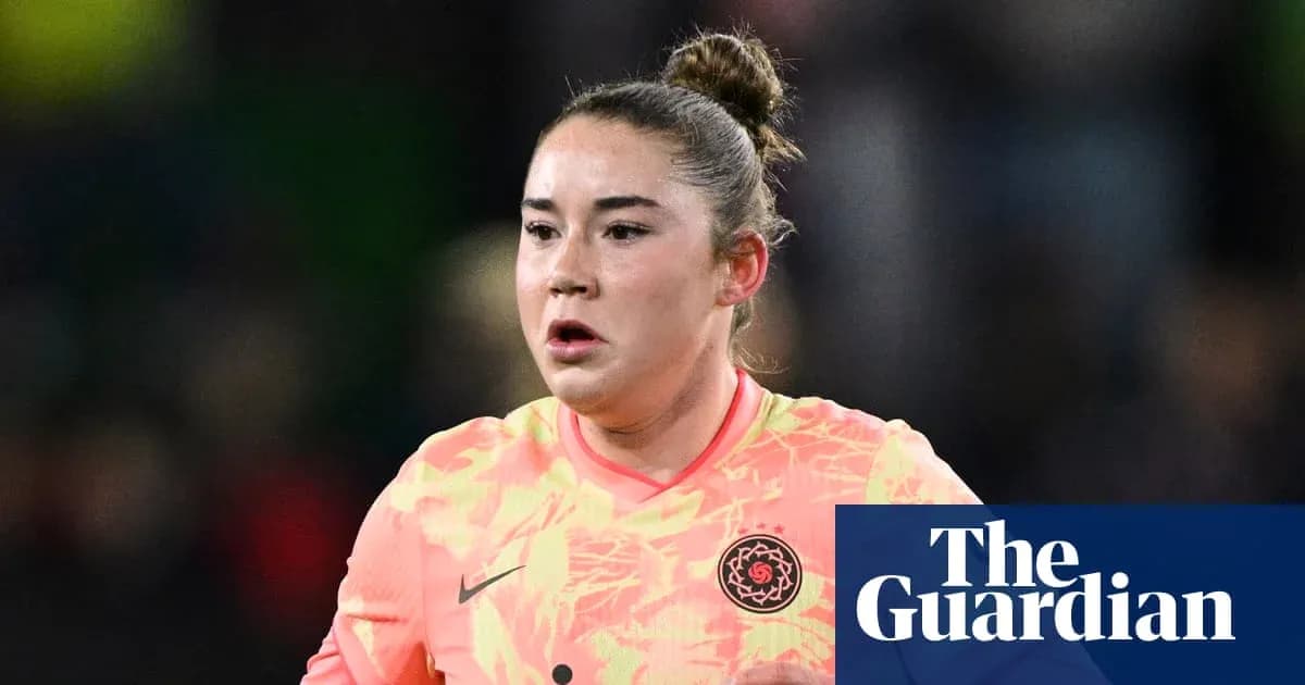 Goalkeeper in bright jersey during match action Goalkeeper in bright jersey during match action