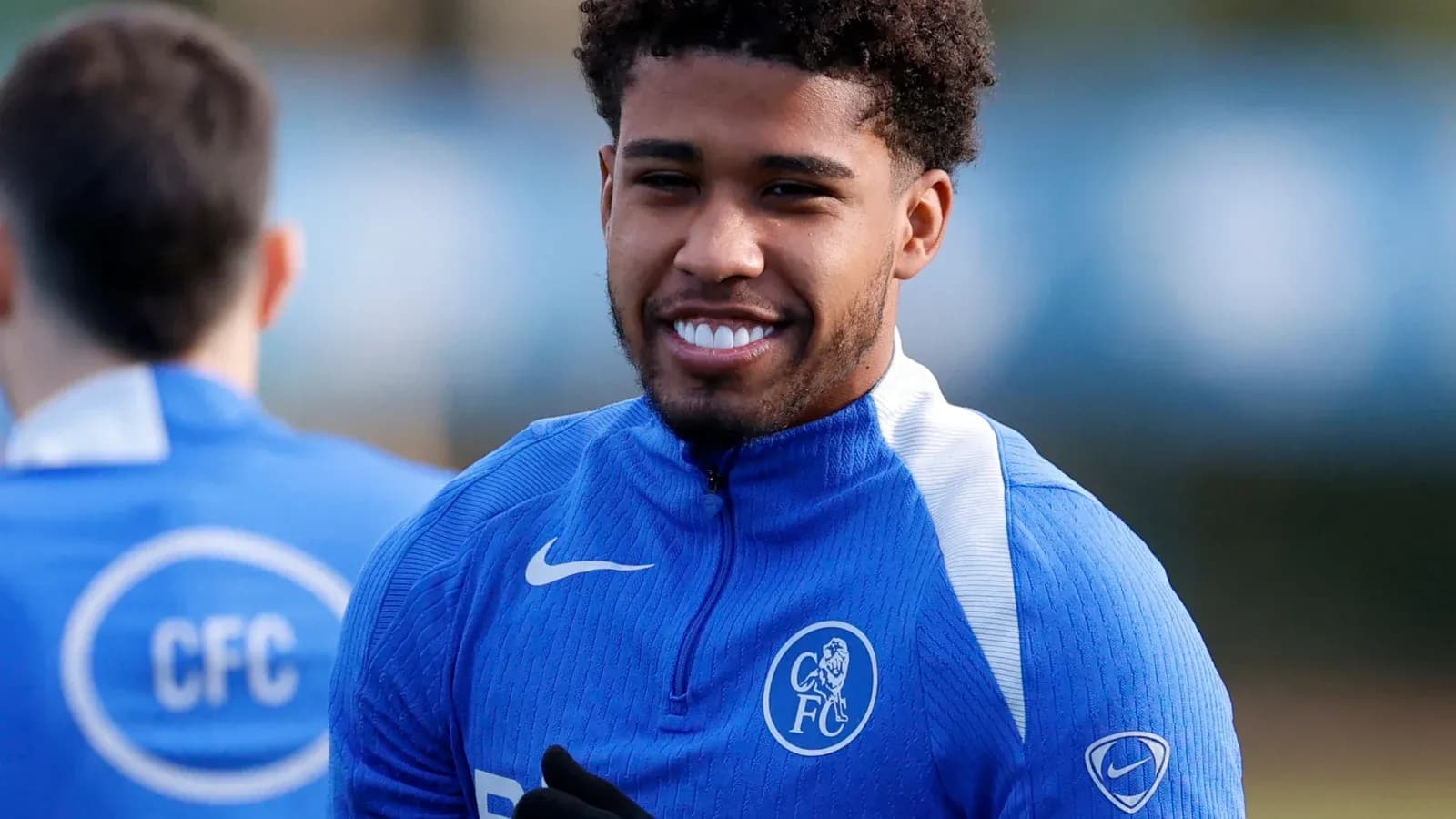 Player smiling during training session in blue kit Player smiling during training session in blue kit