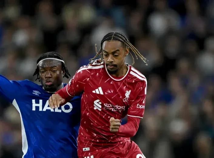 Player in red dribbling past opponent in blue Player in red dribbling past opponent in blue