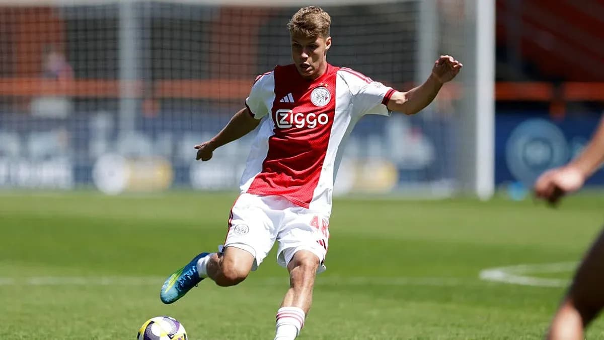 Player in Ajax kit kicking the soccer ball Player in Ajax kit kicking the soccer ball