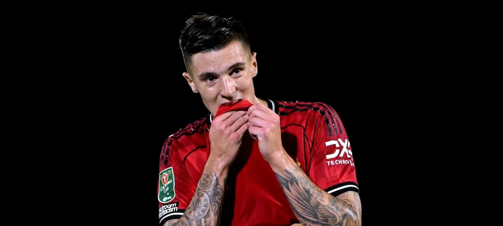 Player in red jersey holding shirt to face Player in red jersey holding shirt to face