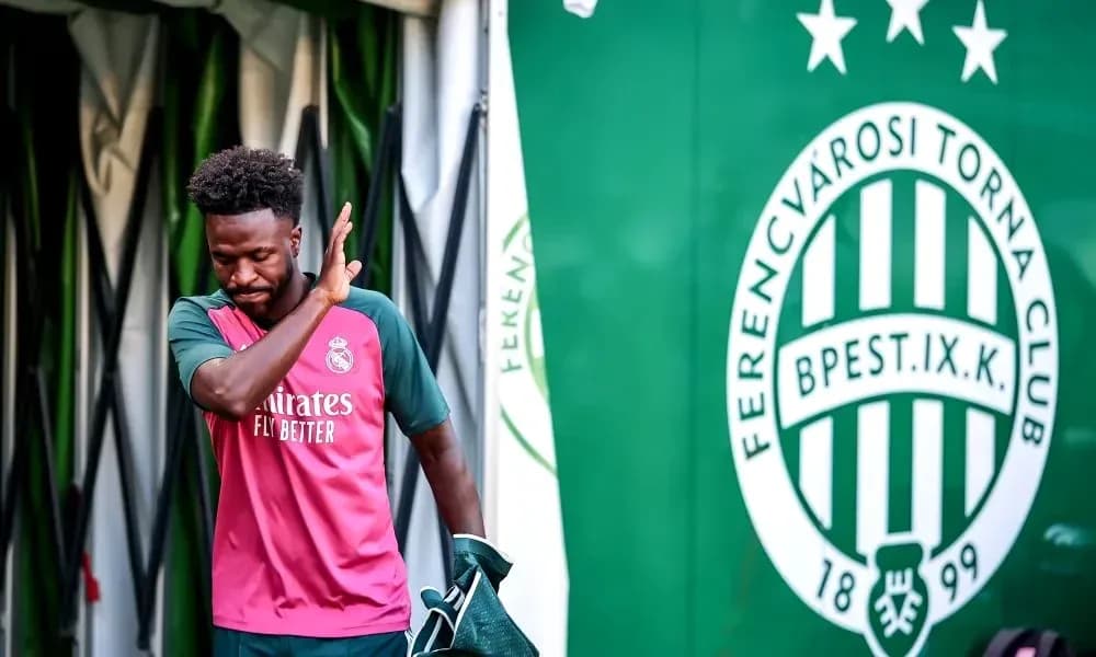 Player walking past Ferencvárosi Torna Club banner Player walking past Ferencvárosi Torna Club banner