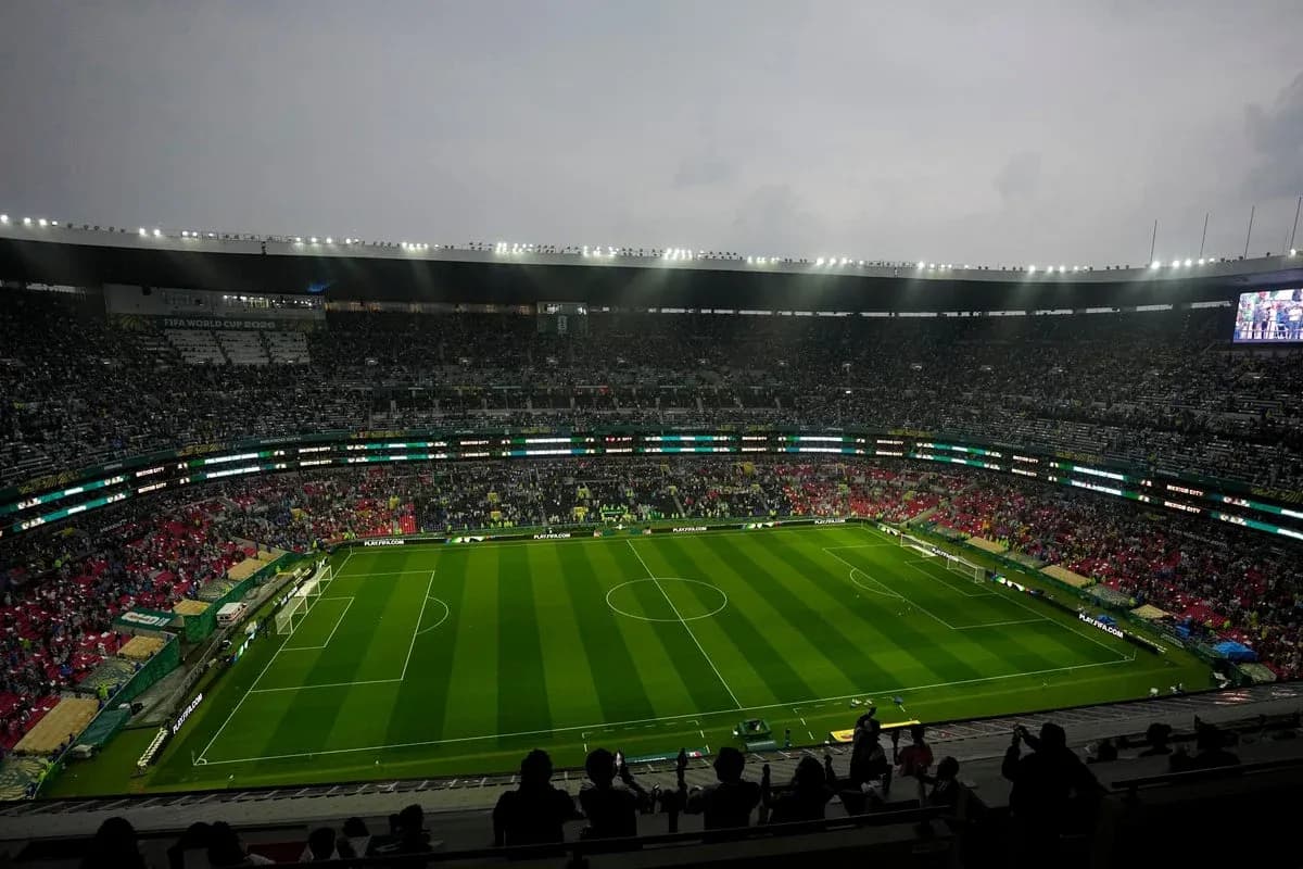 Crowd in stadium before match with green pitch Crowd in stadium before match with green pitch