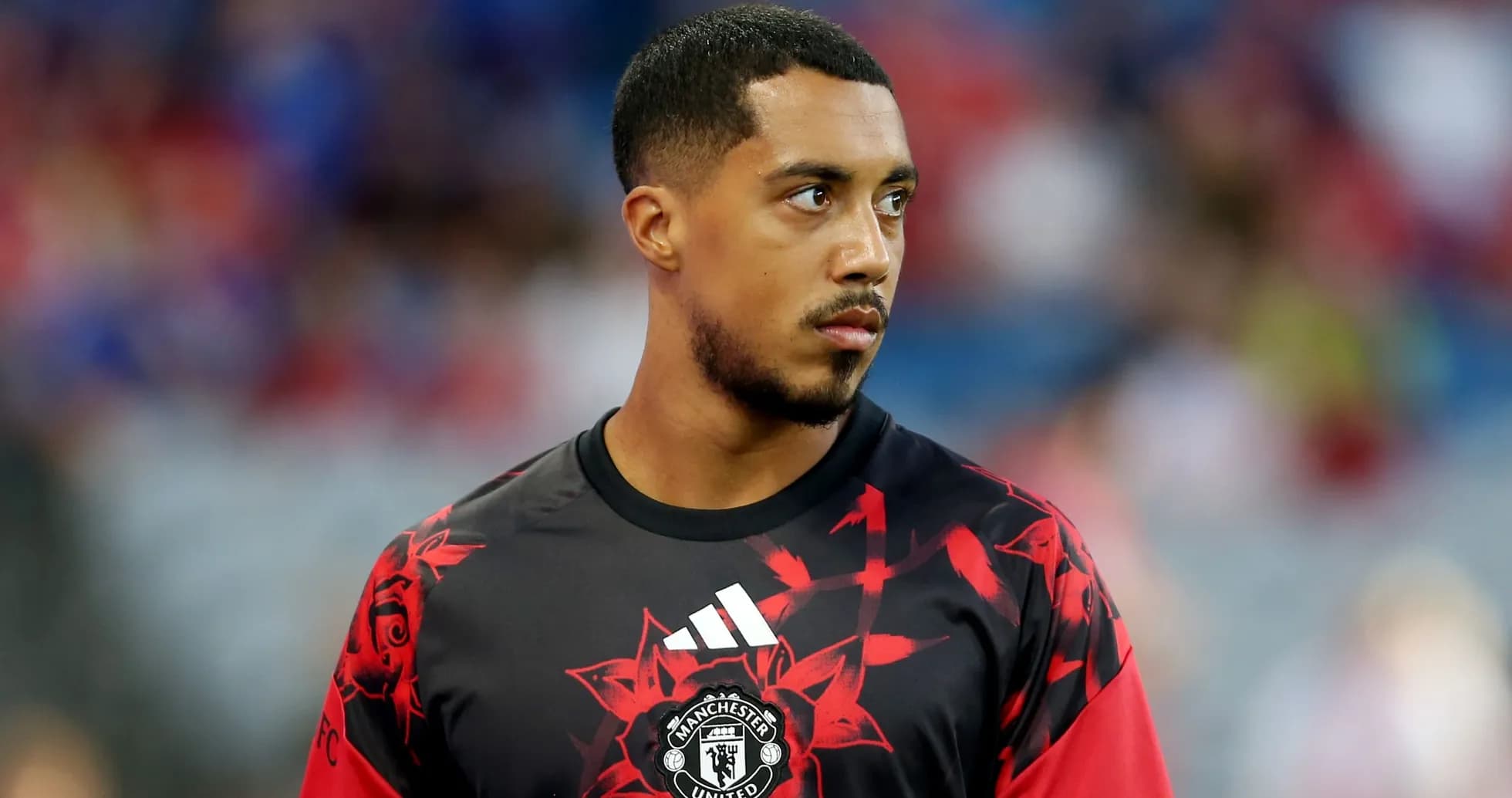 Player in Manchester United training kit on pitch Player in Manchester United training kit on pitch
