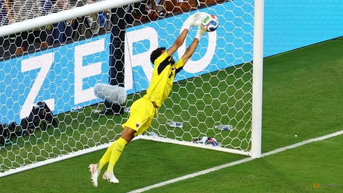Goalkeeper diving to save a shot on goal Goalkeeper diving to save a shot on goal