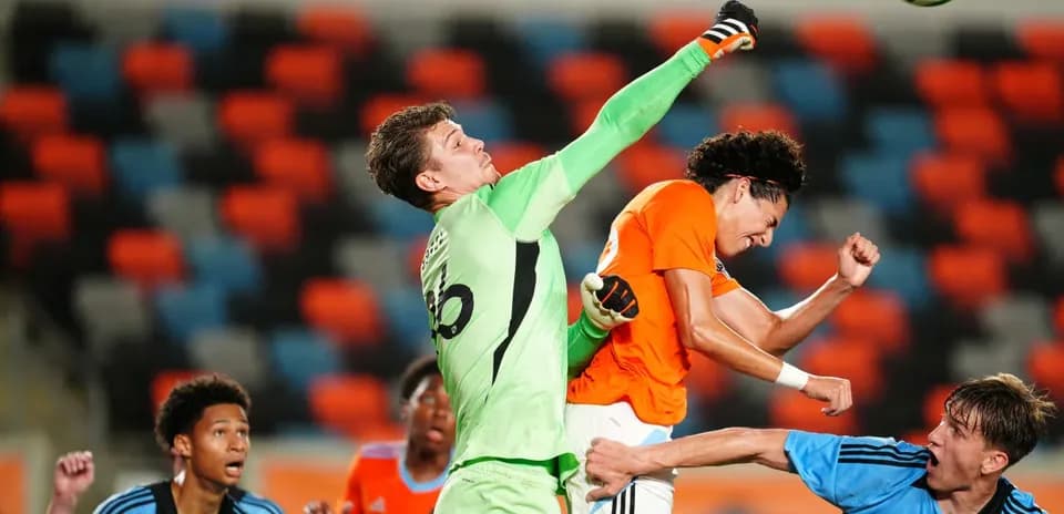 Goalkeeper punching the ball during match action Goalkeeper punching the ball during match action