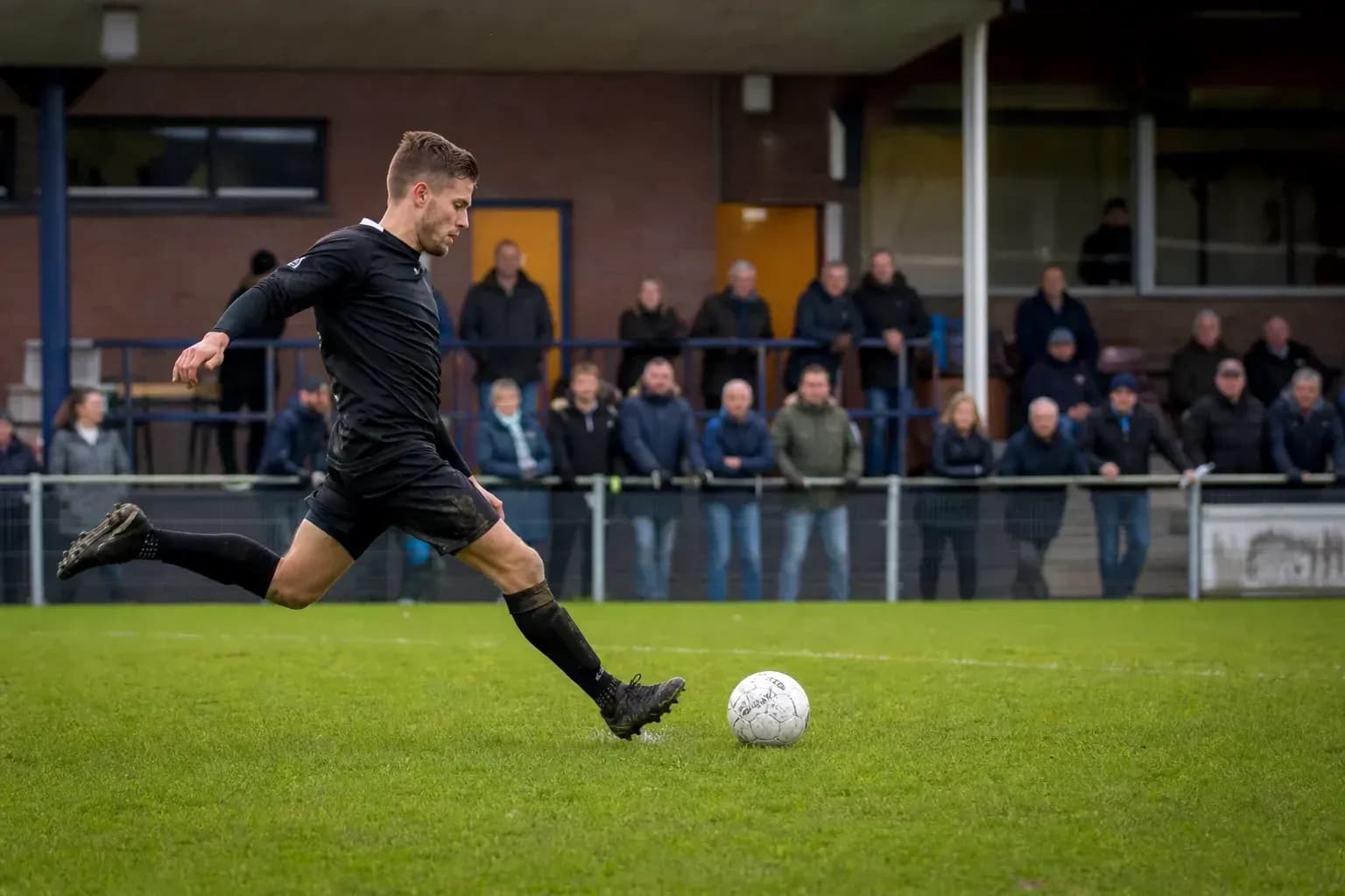 Player kicking a soccer ball on the field Player kicking a soccer ball on the field