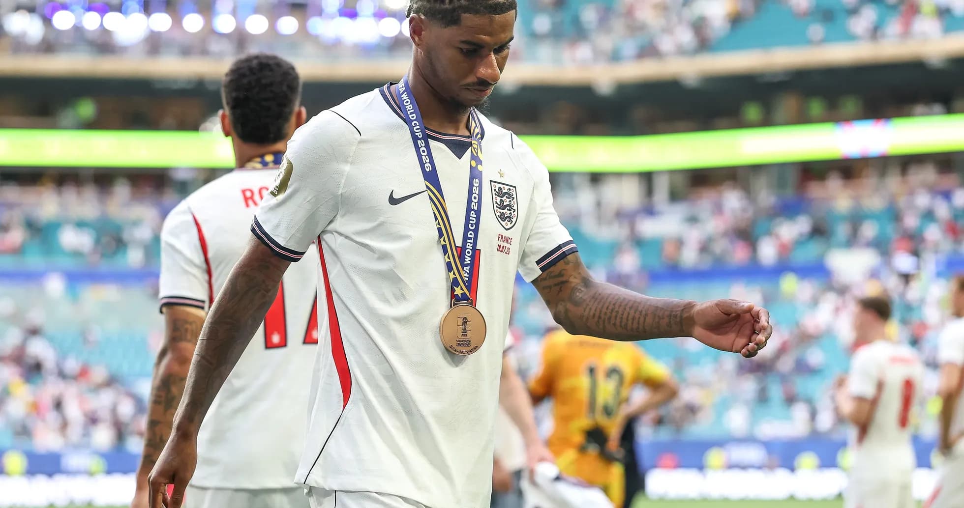 Player walking off field with medal after match Player walking off field with medal after match