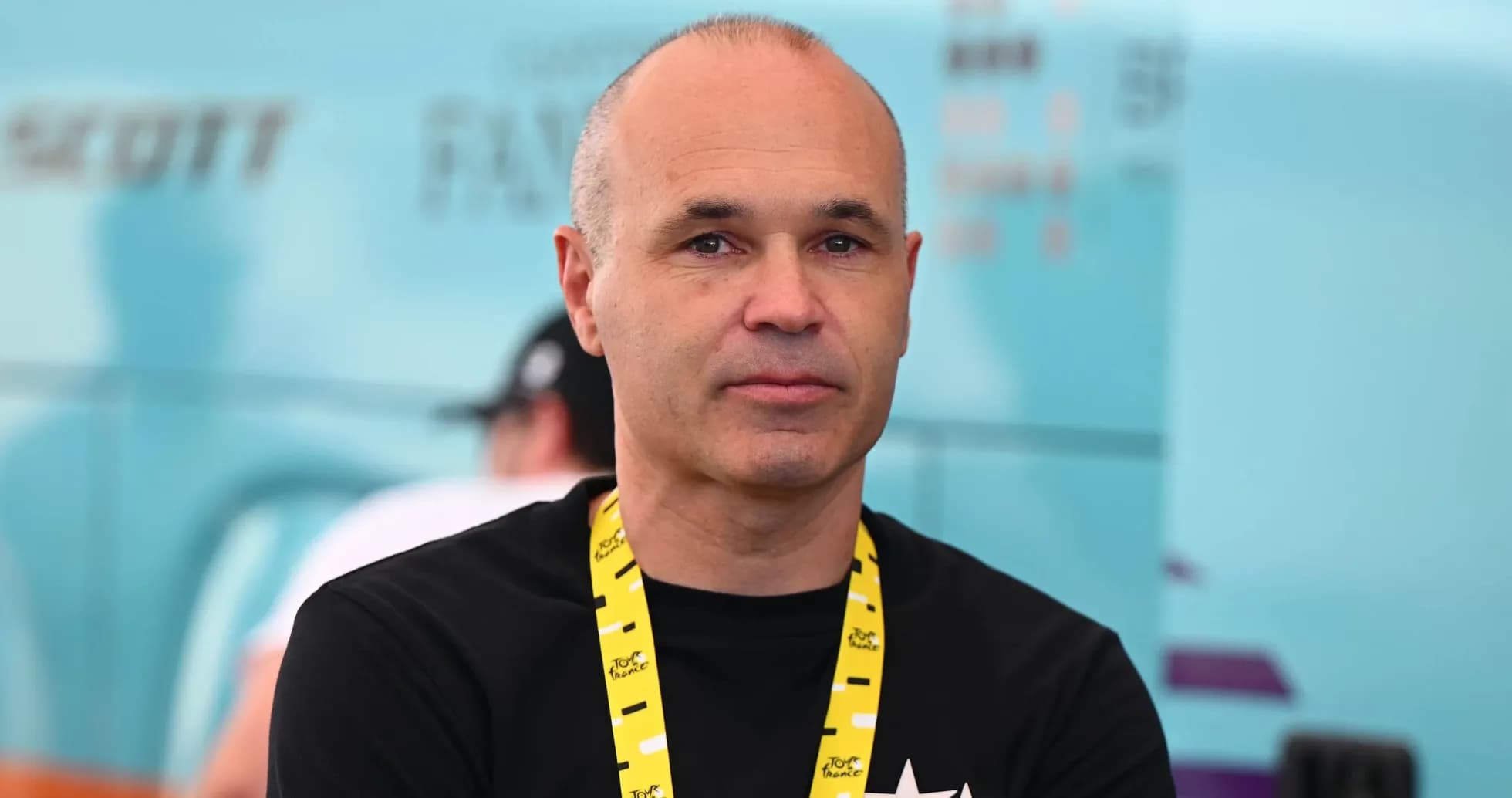 Man with lanyard at cycling event backdrop Man with lanyard at cycling event backdrop