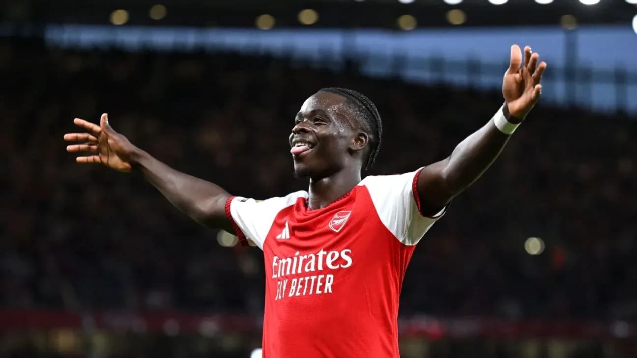 Arsenal player celebrating a goal with arms raised Arsenal player celebrating a goal with arms raised