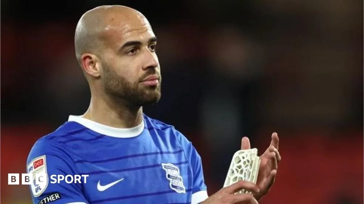 Player in blue jersey applauding fans after match Player in blue jersey applauding fans after match