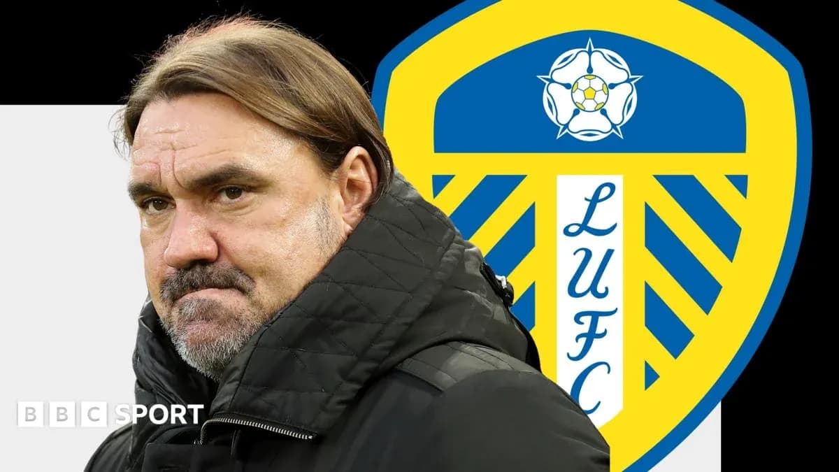 Coach standing in front of Leeds United logo Coach standing in front of Leeds United logo