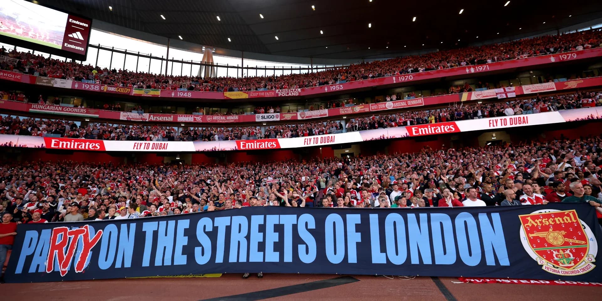 Arsenal fans holding banner at Emirates Stadium Arsenal fans holding banner at Emirates Stadium