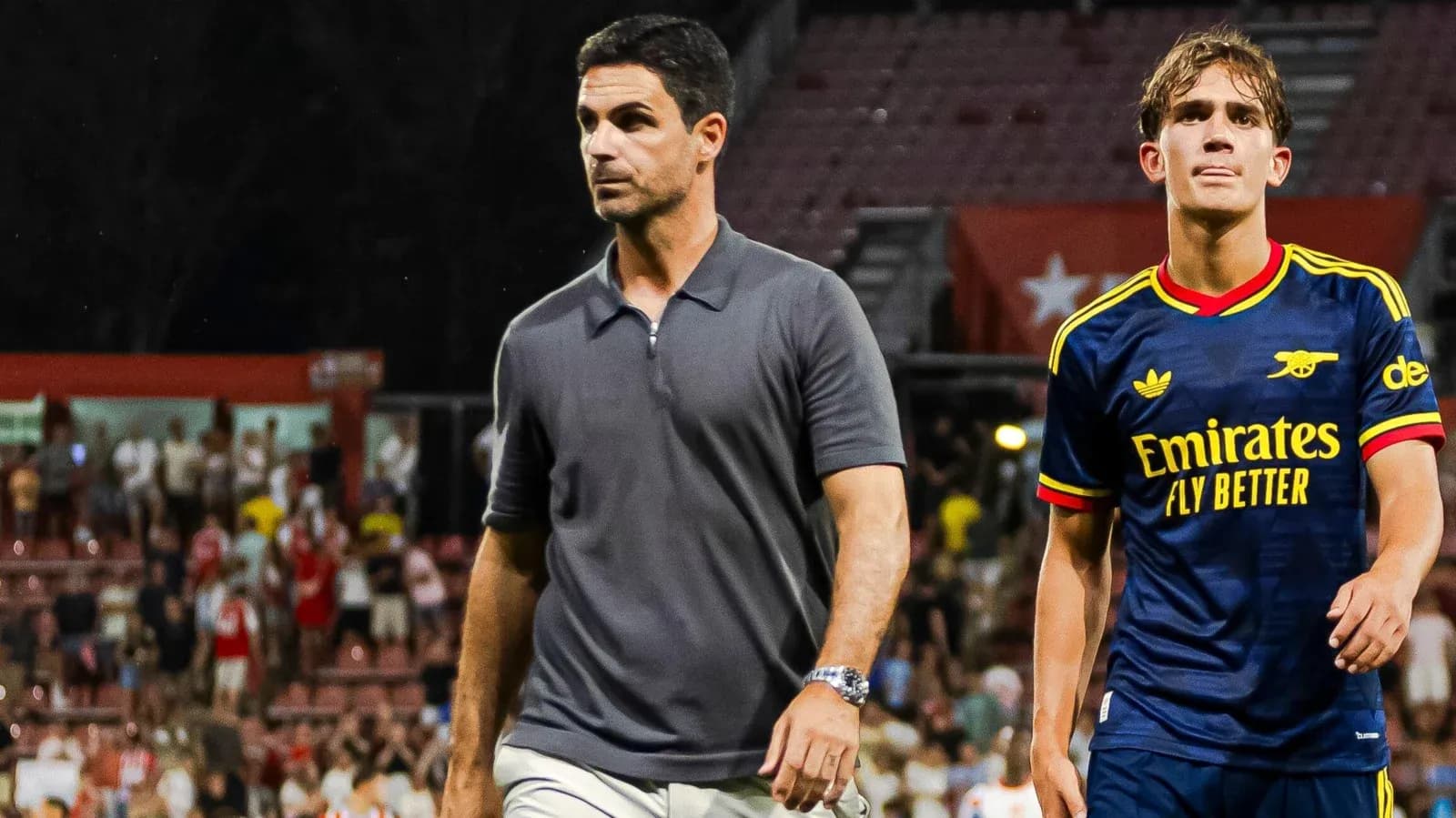 Arsenal manager and player walking off the pitch Arsenal manager and player walking off the pitch