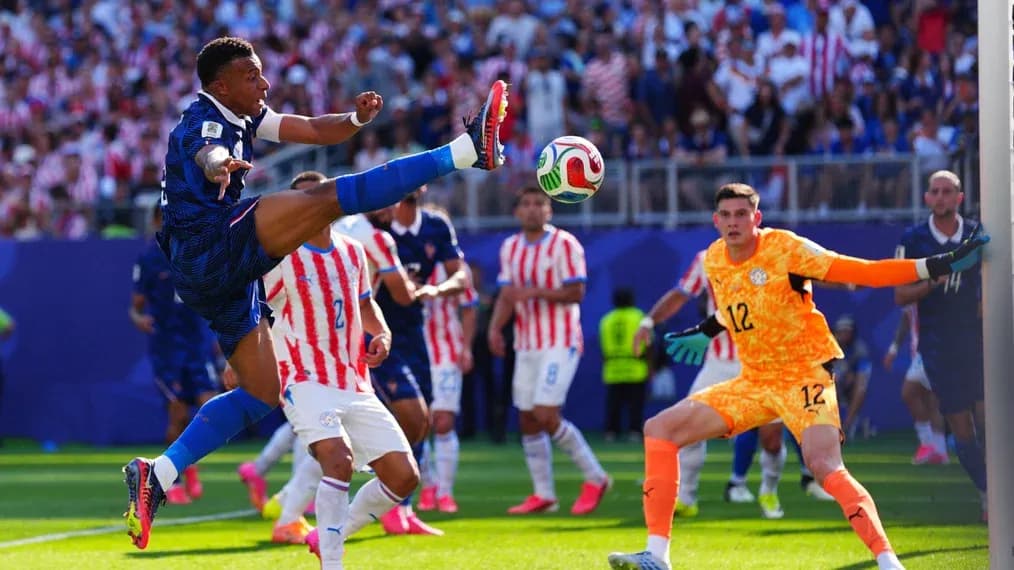 Player kicking ball during match with goalkeeper watching Player kicking ball during match with goalkeeper watching