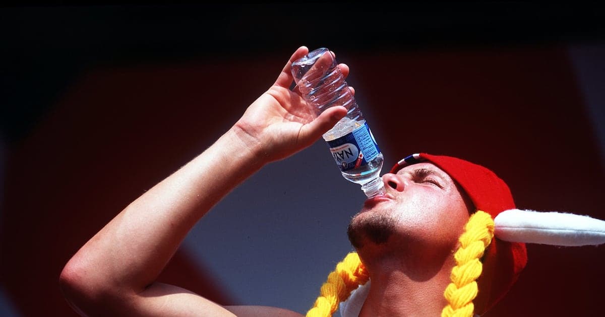 Person drinking water from a bottle Person drinking water from a bottle