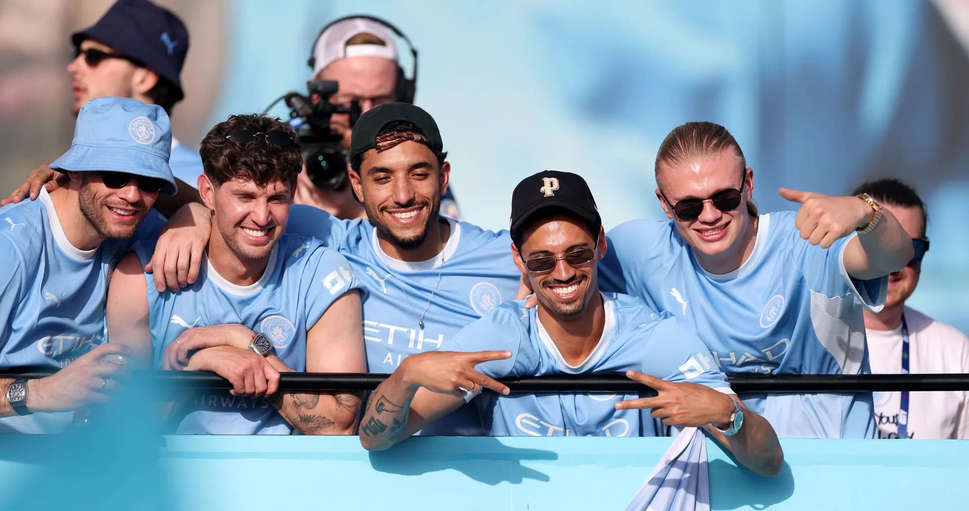 Fans celebrating together in Manchester City jerseys Fans celebrating together in Manchester City jerseys