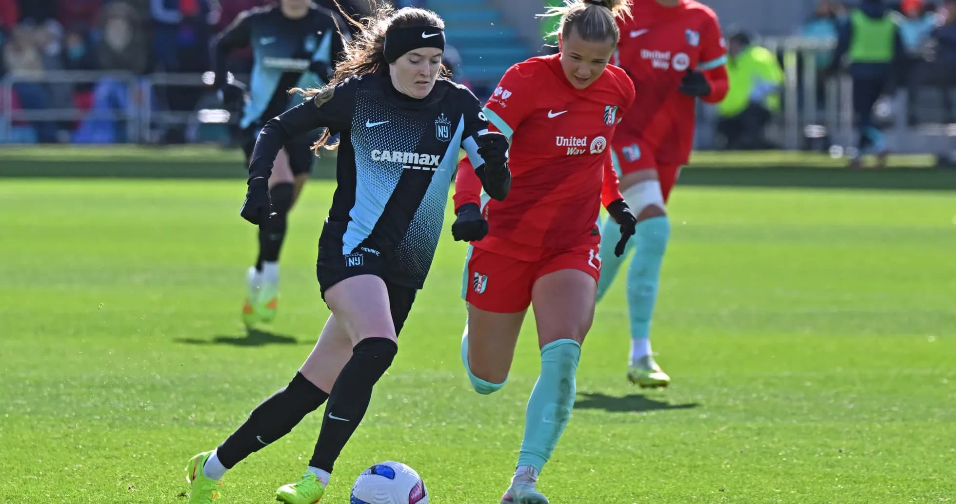 Players competing for the ball during NWSL match Players competing for the ball during NWSL match