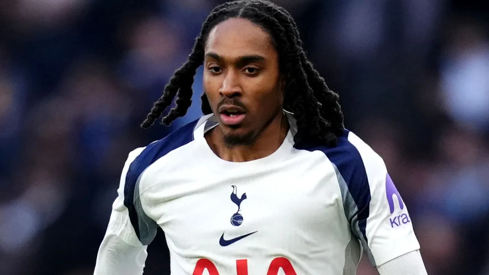 Player in Tottenham jersey running on the field Player in Tottenham jersey running on the field