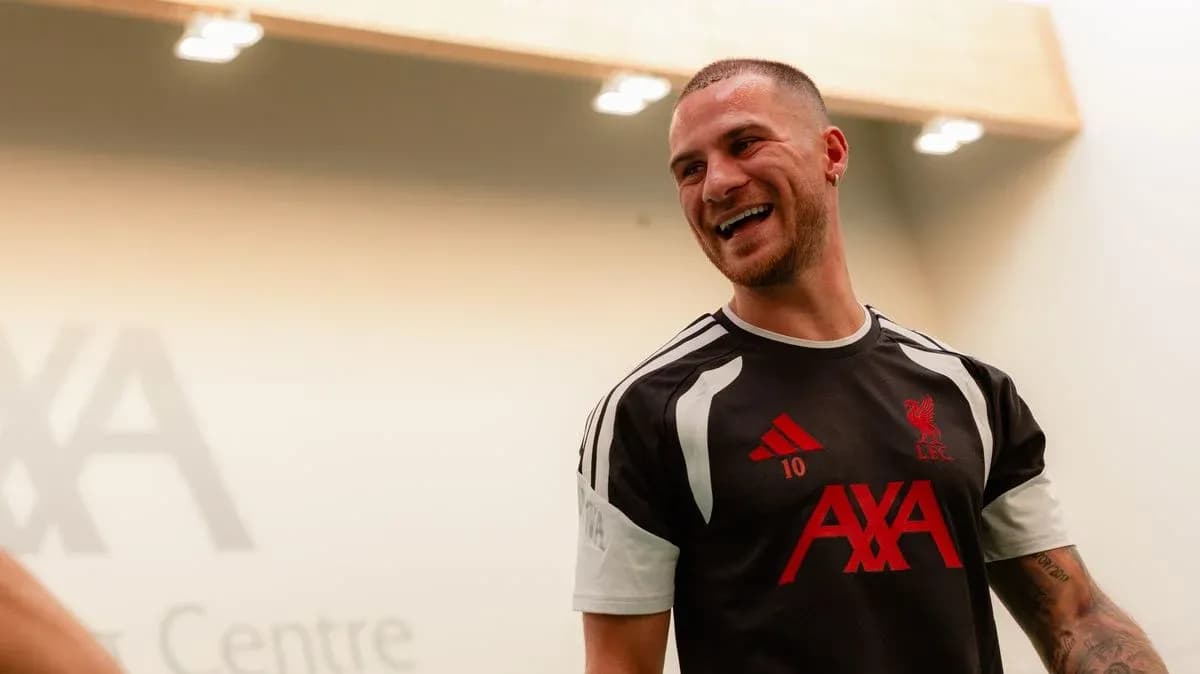 Player smiling in Liverpool training kit at AXA Centre Player smiling in Liverpool training kit at AXA Centre