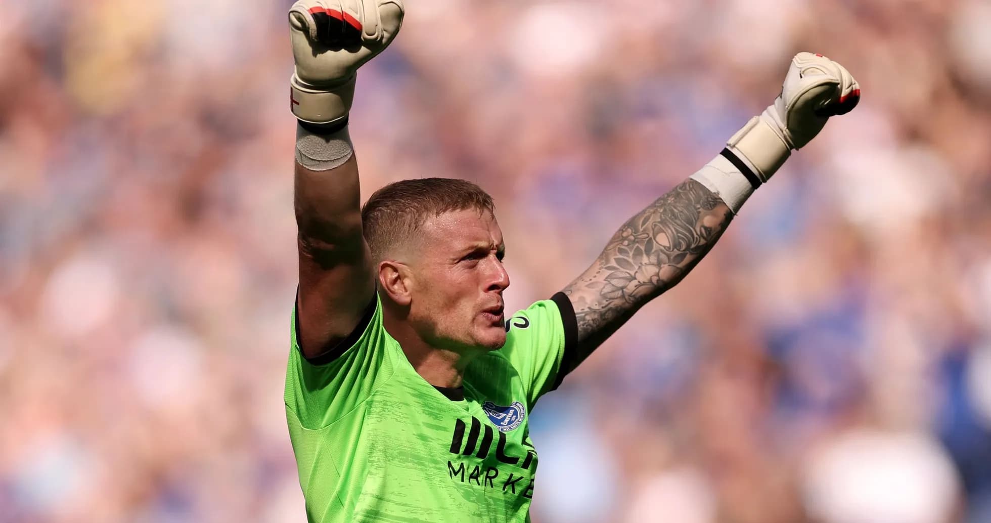 Goalkeeper celebrating with raised arms during match Goalkeeper celebrating with raised arms during match