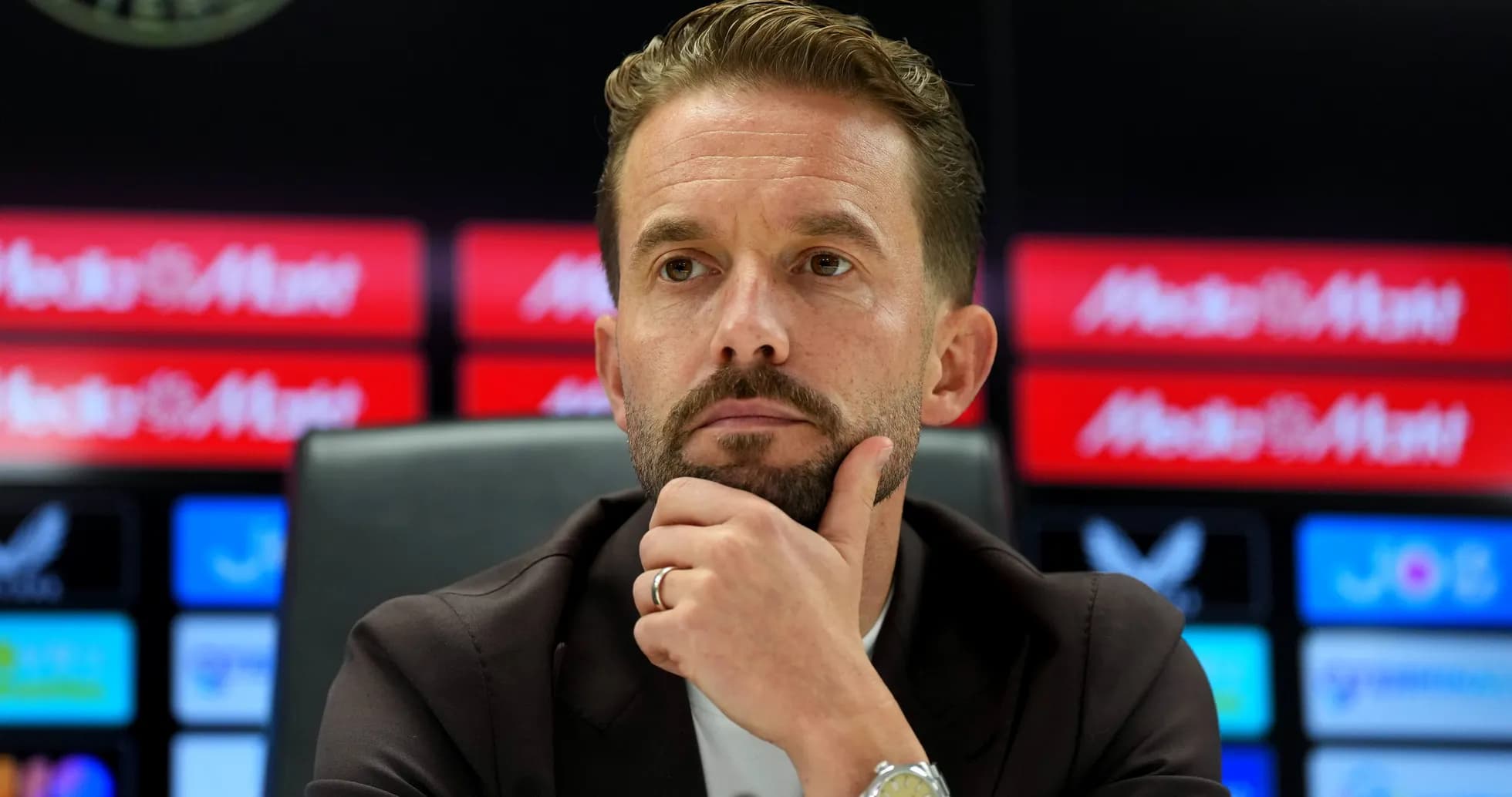 Manager during press conference with thoughtful expression Manager during press conference with thoughtful expression