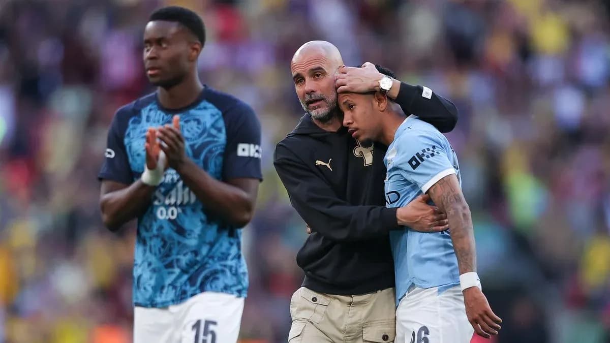 Coach comforting player after match, teammates nearby Coach comforting player after match, teammates nearby