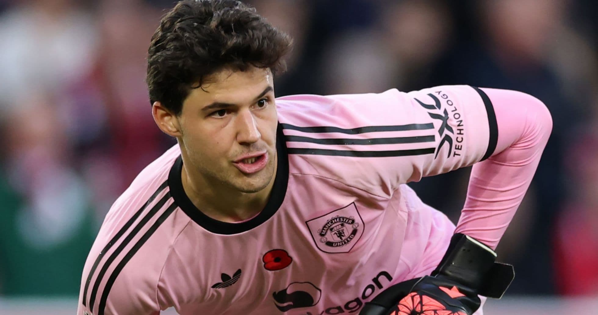 Goalkeeper in pink kit preparing for play Goalkeeper in pink kit preparing for play
