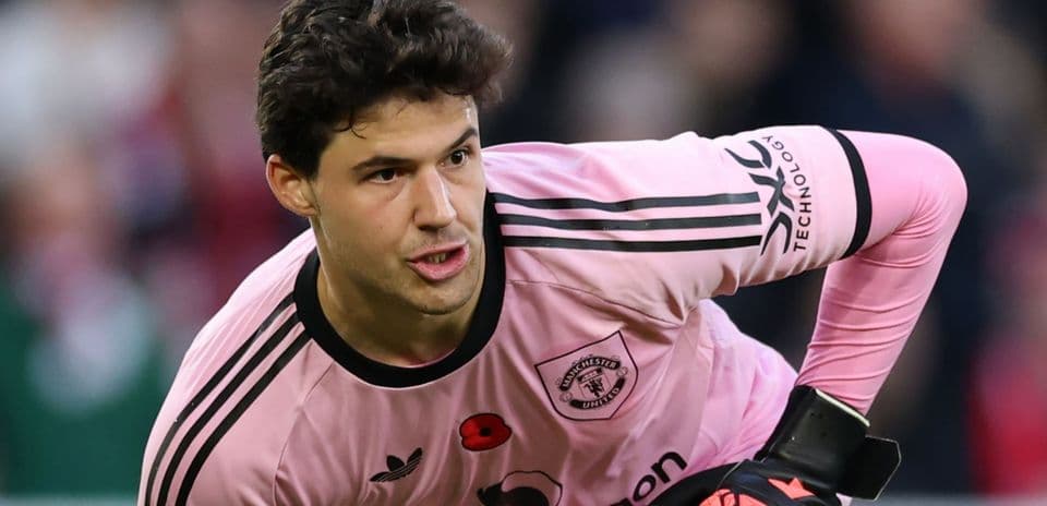 Goalkeeper in pink kit preparing for play Goalkeeper in pink kit preparing for play