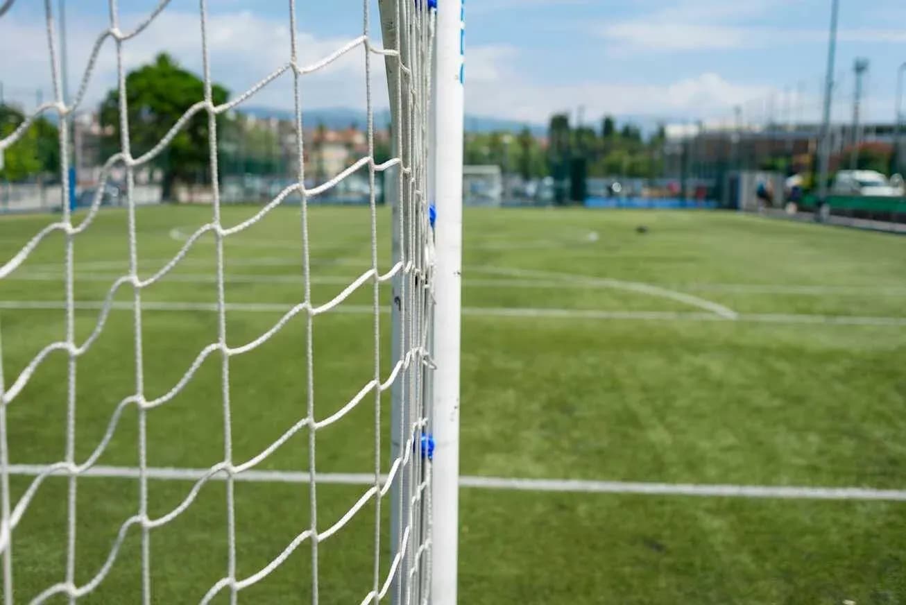 Soccer goalpost and net on grassy field Soccer goalpost and net on grassy field