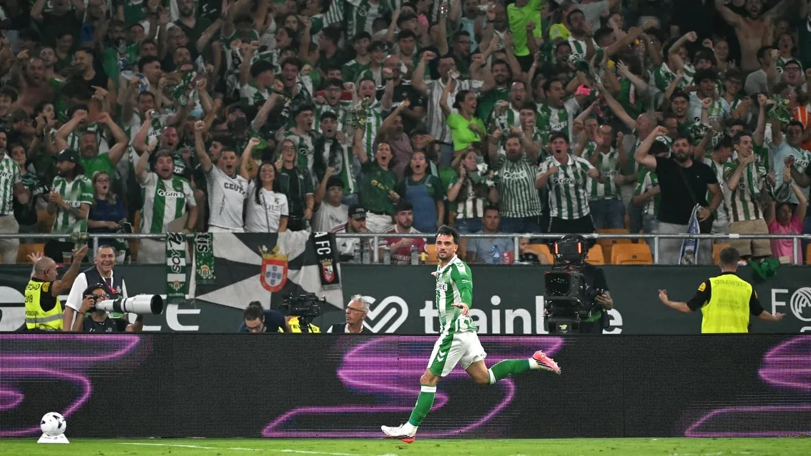 Player celebrating a goal in front of fans Player celebrating a goal in front of fans
