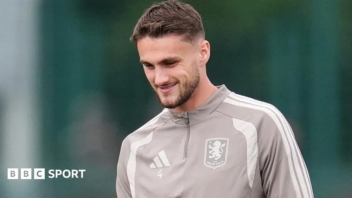 Player in Aston Villa training gear smiling outdoors Player in Aston Villa training gear smiling outdoors