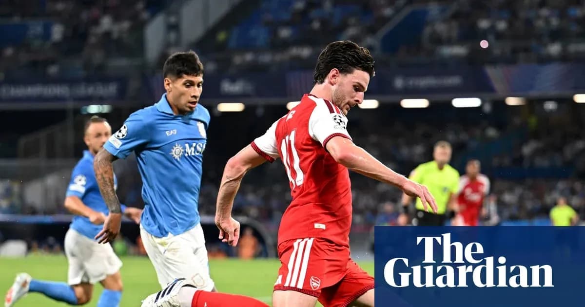 Player in red dribbling the ball during match Player in red dribbling the ball during match