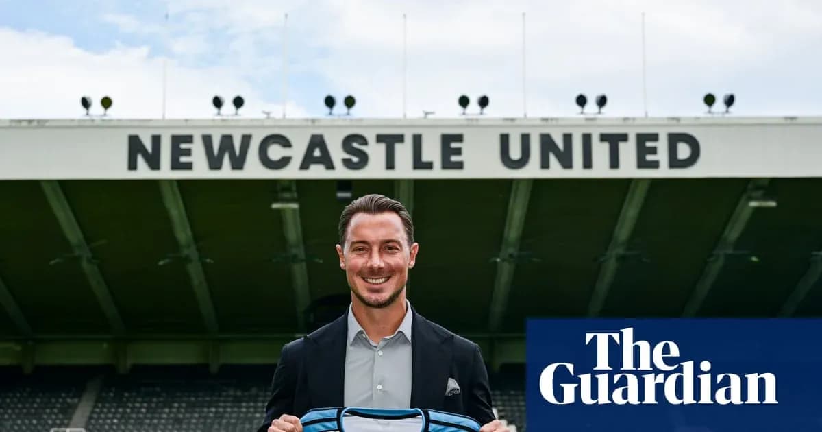 Player holding Newcastle United jersey at stadium Player holding Newcastle United jersey at stadium