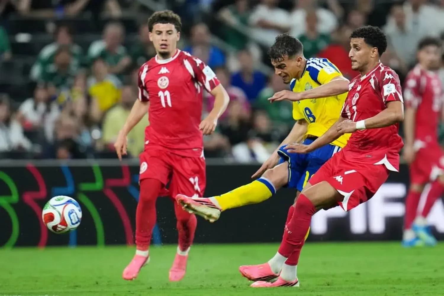 Sweden and Tunisia players competing for the ball Sweden and Tunisia players competing for the ball