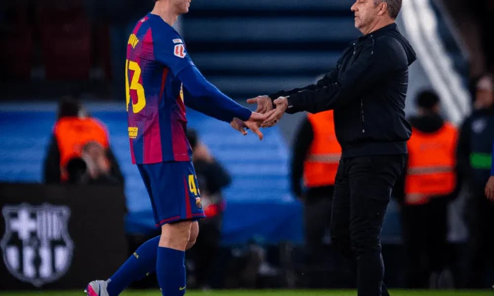 Player and coach shaking hands on the pitch Player and coach shaking hands on the pitch
