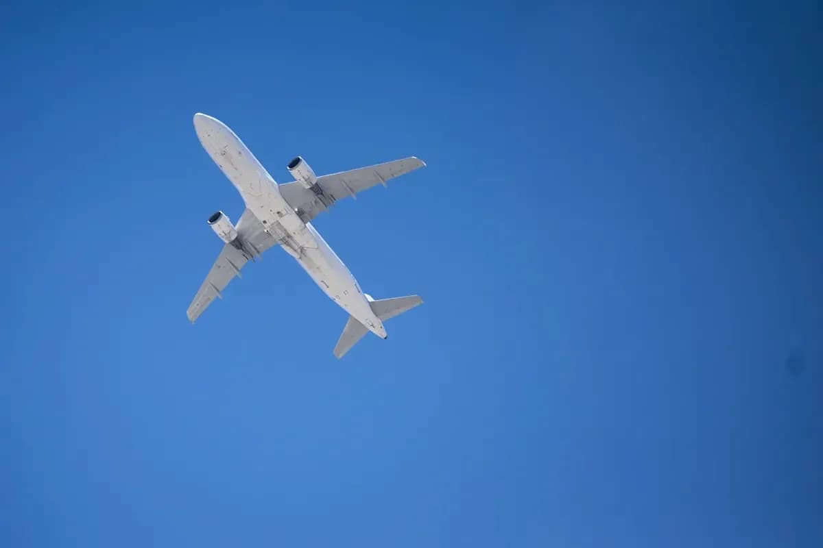 Airplane flying against a clear blue sky Airplane flying against a clear blue sky