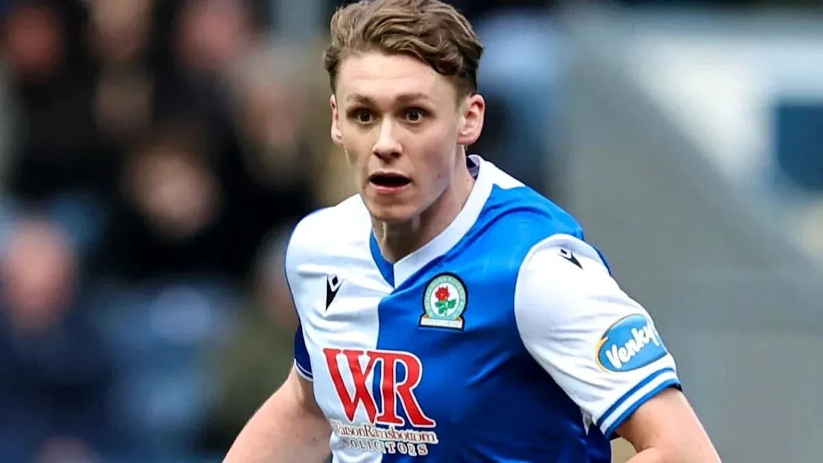 Player in Blackburn Rovers kit running on field Player in Blackburn Rovers kit running on field