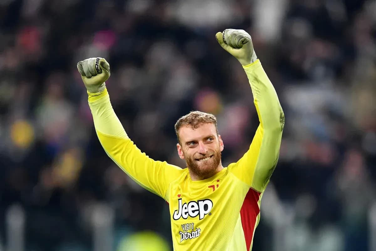 Goalkeeper celebrating with raised arms after match Goalkeeper celebrating with raised arms after match