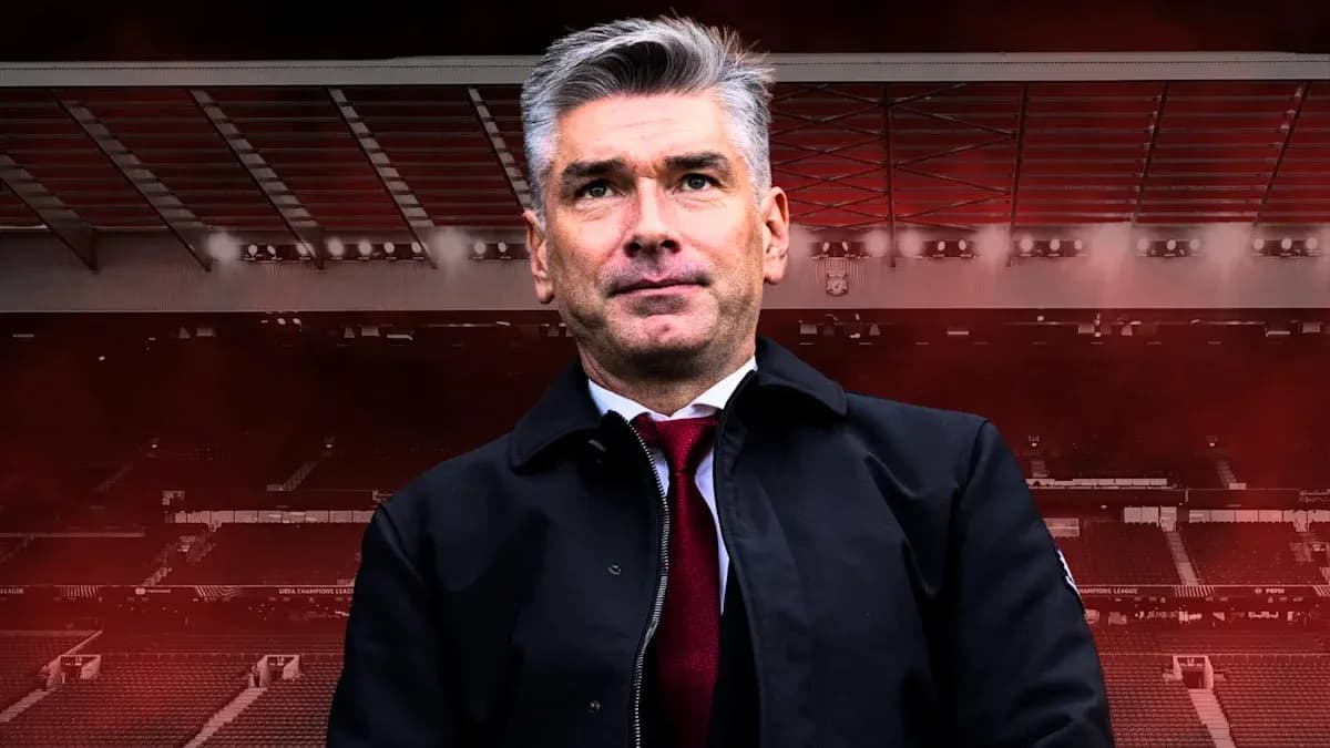 Manager standing in stadium with red backdrop Manager standing in stadium with red backdrop