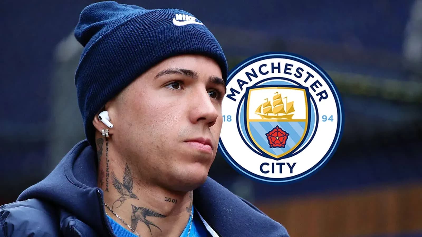 Player wearing headphones near Manchester City logo Player wearing headphones near Manchester City logo