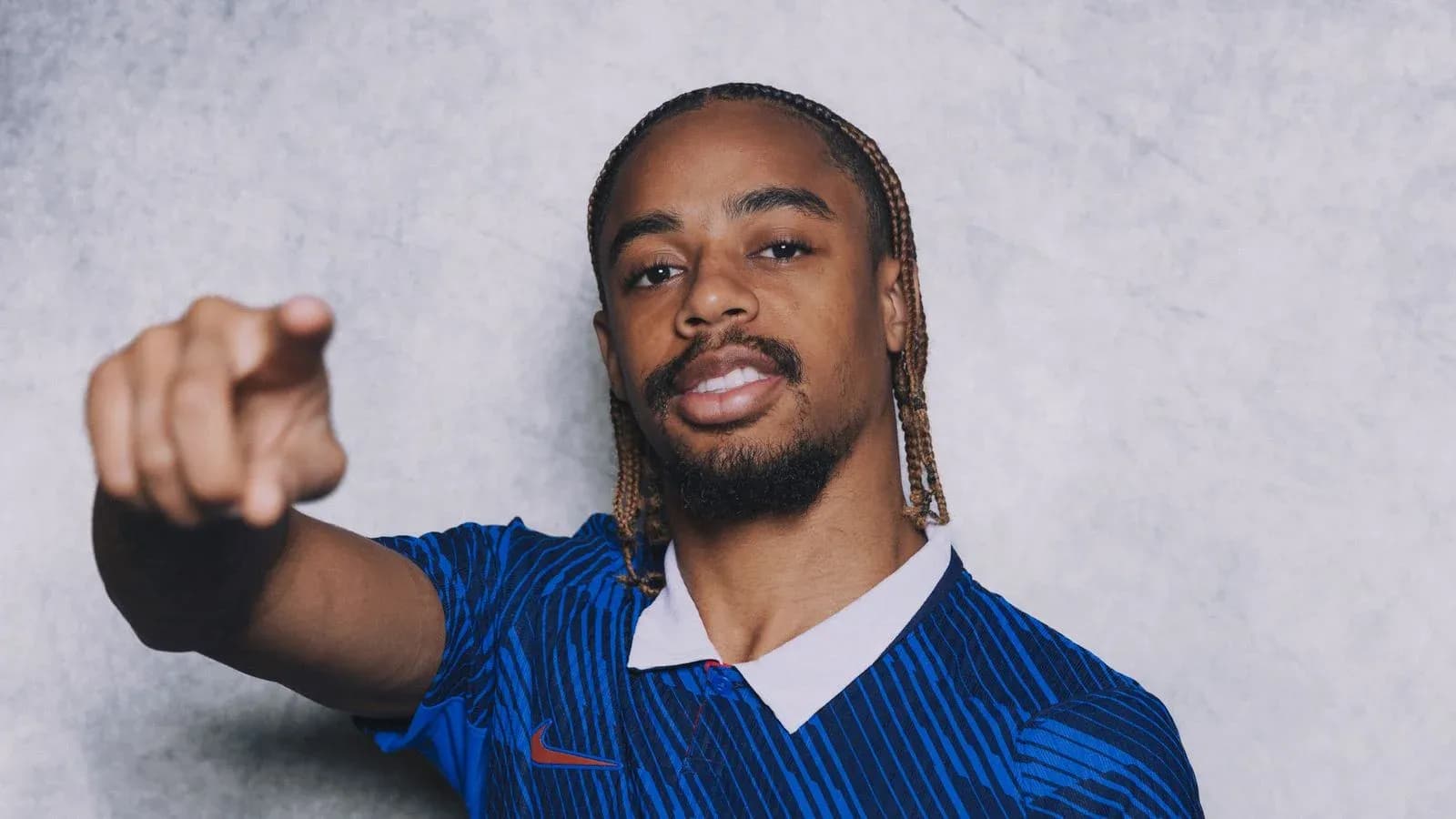 Football player pointing while wearing blue jersey Football player pointing while wearing blue jersey